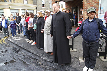 Local community get together to clear damage caused by rioters in Hackney, London, UK ;