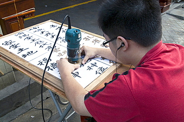 China sign-maker with calligraphic skills in the old quarter in guangzhou, guangdong province