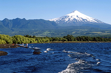 Chile, tourists visiting the osorno volcano and lake in the southern region.