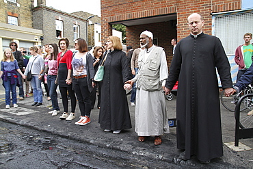 Local community get together to clear damage caused by rioters in Hackney, London, UK ;