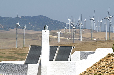 Spain. Wind turbines and houses with solar panels in rural areas in andalucia