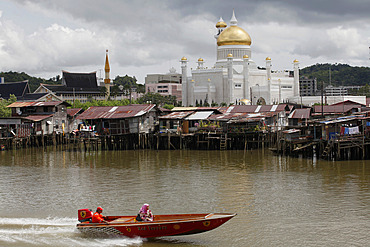 Boats past water village with Omar Ali Saifuddien mosque in Bandar Seri Begawan, Brunei, Southeast Asia, Asia