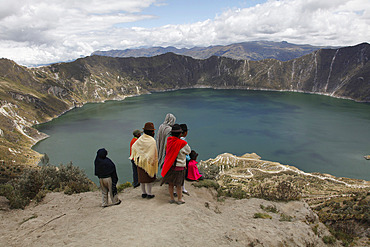 Native people and tourists visit the Laguna de Quilotoa crater lake near Latacunga, Ecuador, South America