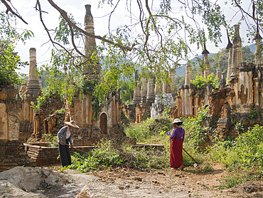 Local women cleaning area by old Buddhist temples in the Inle Lake region, Shan State, Myanmar (Burma), Asia