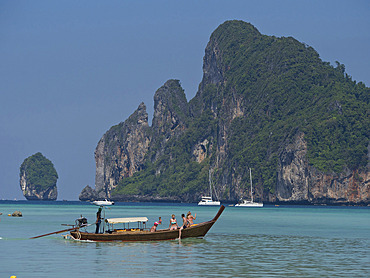 Tourists on long-tail boat in the Phi Phi islands, Andaman sea, Thailand, Southeast Asia, Asia