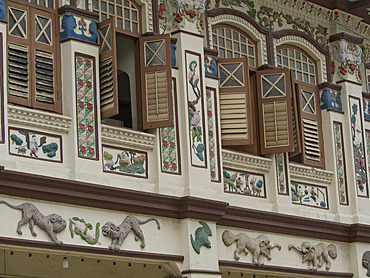 Lorong Bachok shophouse and cultural association with classic Chinese tales depicted beneath the windows in the Geylang area of Singapore, Southeast Asia, Asia