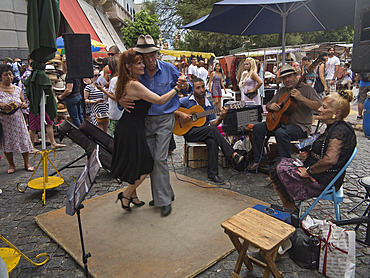 Tango dancers and musicians in the streets of the old barrio of San Telmo, Buenos Aires, Argentina, South America