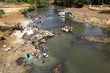 Local people washing and doing their laundry in a river in the highlands of Ethiopia, Africa