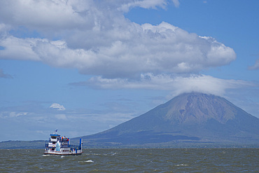 Passenger ferry and volcano with Ometepe Island in background, Nicaragua, Central America