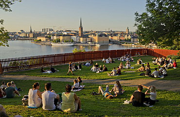 Young people picnic at sunset in the summer in the fashionable Sodermalm neighbourhood and district of Stockholm, Sweden, Scandinavia, Europe