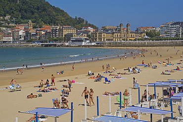 People enjoy the seaside at La Concha beach in San Sebastian, Basque Country, Euskadi, Spain, Europe