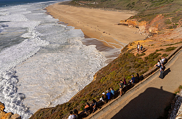 View of windy surfing north beach, fort and lighthouse in Nazare ,Portugal, host to one of the World's major surf competitions with 30m waves