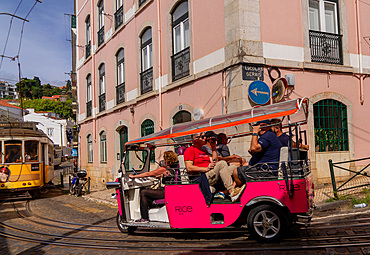 Trams and tourist buggies in the Alfama old town area of Lisbon,Portugal