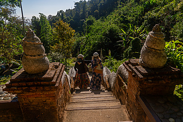 Visitors to the Wat Pha Lat Buddhist temple in the hills above Chiang Mai, Thailand