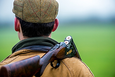 Gun with gun cocked over his shoulder faving away from the camera, United Kingdom, Europe