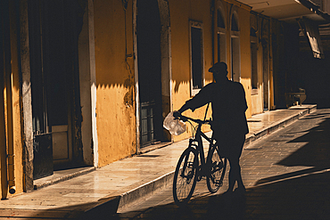 Silhouette of a man on his bike in Corfu Town