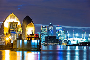 Thames Barrier, Millennium Dome (O2 Arena) and Canary Wharf at night, London, England, United Kingdom, Europe