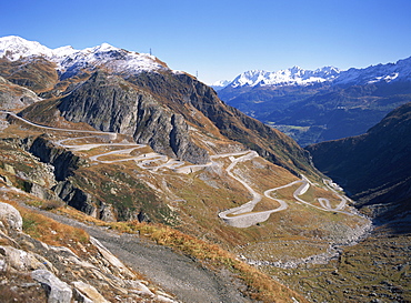 The old road snaking up the southern side of the St. Gotthard Pass, with first autumn snow on the mountains, in Ticino, Switzerland, Europe