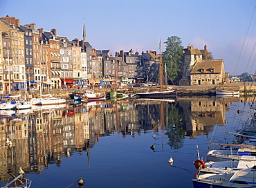 Reflections of houses and boats in the old harbour at Honfleur, Basse Normandie, France, Europe