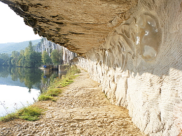 Modern carvings by D. Monnier on wall of tow path beside River Lot, near St. Cirq-Lapopie, east of Cahors, Midi-Pyrenees, France, Europe