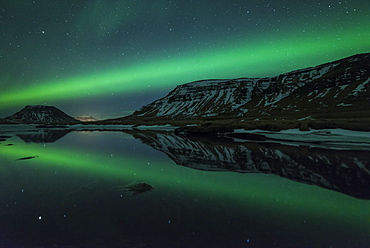 Aurora borealis (Northern Lights) reflected in partially frozen lake, North Snaefellsnes, Iceland, Polar Regions