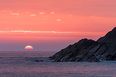 Cliff and ocean at sunset, Clogher Bay, Dingle Peninsula, County Kerry, Munster, Republic of Ireland, Europe