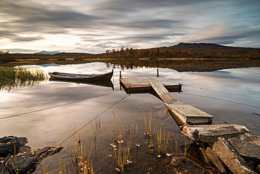 Boat moored to floating pontoon at sunset, Senja, Norway, Scandinavia, Europe