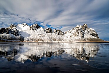 Vestrahorn Mountain reflected in wet sand, Iceland, Polar Regions