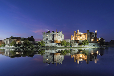 Leeds Castle at night, illuminated, reflected in moat, near Maidstone, Kent, England, United Kingdom, Europe