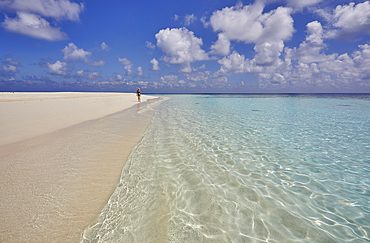 Pristine shallow waters lap against the white coral sand of a tropical beach; Havodda Island, in the far south of the Maldives, Gaafu Dhaalu atoll, Indian Ocean.