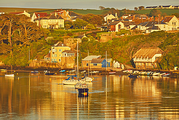 An evening sunlight view of the estuary of the River Avon, with the village of Bantham, on the south coast of Devon, Great Britain.