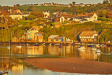 An evening sunlight view of the estuary of the River Avon, with the village of Bantham, on the south coast of Devon, Great Britain.
