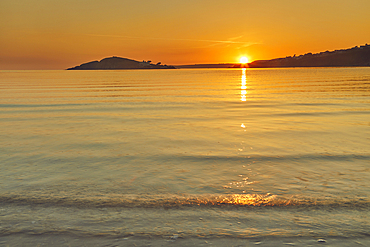 Sunset over Burgh Island, near Bigbury-on-Sea, seen from Bantham, on the south coast of Devon, Great Britain.