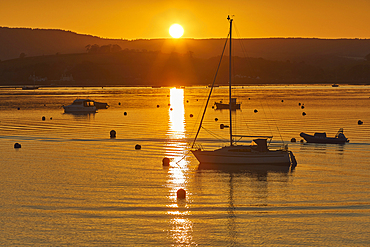 A calm and clear sunset over the estuary of the River Exe, at Exmouth, on the coast of Devon, Great Britain.