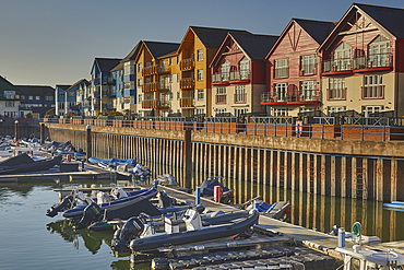 Apartment buildings around the harbour at Exmouth bathed in evening sunlight, Devon, Great Britain.