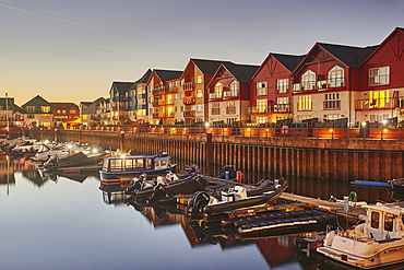 A dusk view of the harbour and surrounding apartments at Exmouth, on the coast of Devon, Great Britain.