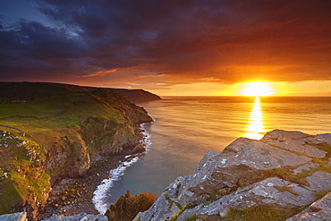 Sunset over coastal cliffs seen from the Valley of Rocks, Lynton, Exmoor National Park, Devon, England, United Kingdom, Europe