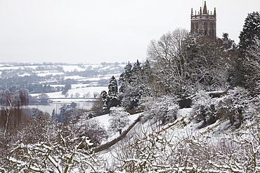 A wintry, snow-bound view of Blagdon Church, with Blagdon Lake in the background, Blagdon, Somerset, England, United Kingdom, Europe