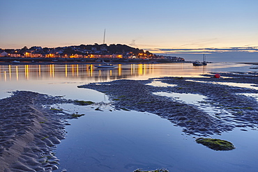 A dusk view across the estuary of the River Torridge from Instow, looking towards the lights of Appledore, in north Devon, England, United Kingdom, Europe