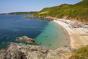 Classic Devon coastline, the rocks, beach and blue waters of Mattiscombe Bay, near Start Point, on the south coast of Devon, England, United Kingdom, Europe