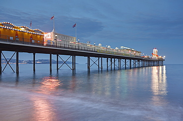 A dusk view of a classic seaside pier, Paignton Pier, Torbay, Devon, England, United Kingdom, Europe