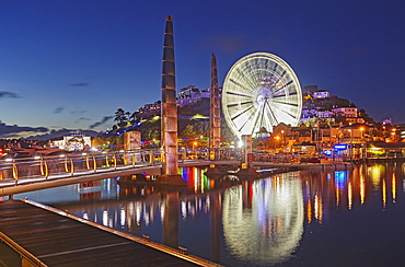 An atmospheric dusk view across Torquay Marina to the town of Torquay, on the south coast of Devon, England, United Kingdom, Europe