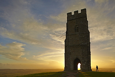 St. Michael's Tower silhouetted at sunset, on the summit of Glastonbury Tor, Glastonbury, Somerset, England, United Kingdom, Europe