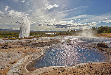 An Icelandic icon, a hot pool with Strokkur Geysir behind, at Geysir, Iceland, Polar Regions