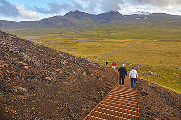 Exploring a volcanic landscape on a footpath up Saxholl cinder cone and crater, Snaefellsjokull National Park, western Iceland, Polar Regions