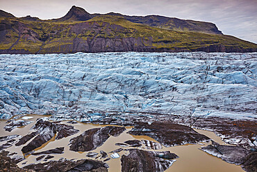 Melting ice at the foot of a retreating glacier, Svinafellsjokull, Skaftafell National Park, southern Iceland, Polar Regions