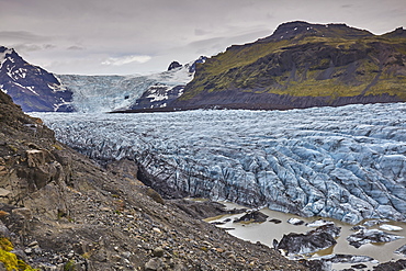 A retreating glacier, pouring down from the Vatnajokull icecap, in Skaftafell National Park, southern Iceland, Polar Regions