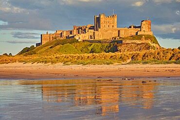 Bamburgh Castle and its beach, at Bamburgh, near Seahouses, Northumberland, England, United Kingdom, Europe