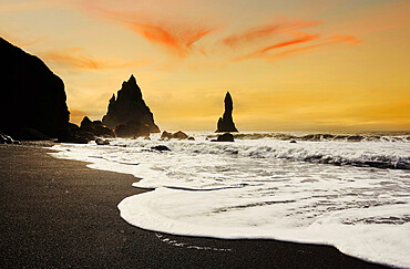 Silhouetted offshore rocks along the coast at Reynisfjara, near Vik, south coast of Iceland, Polar Regions