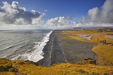 A view from Dyrholaey Island along a vast volcanic black sand beach, near the town of Vik, on the south coast of Iceland, Polar Regions